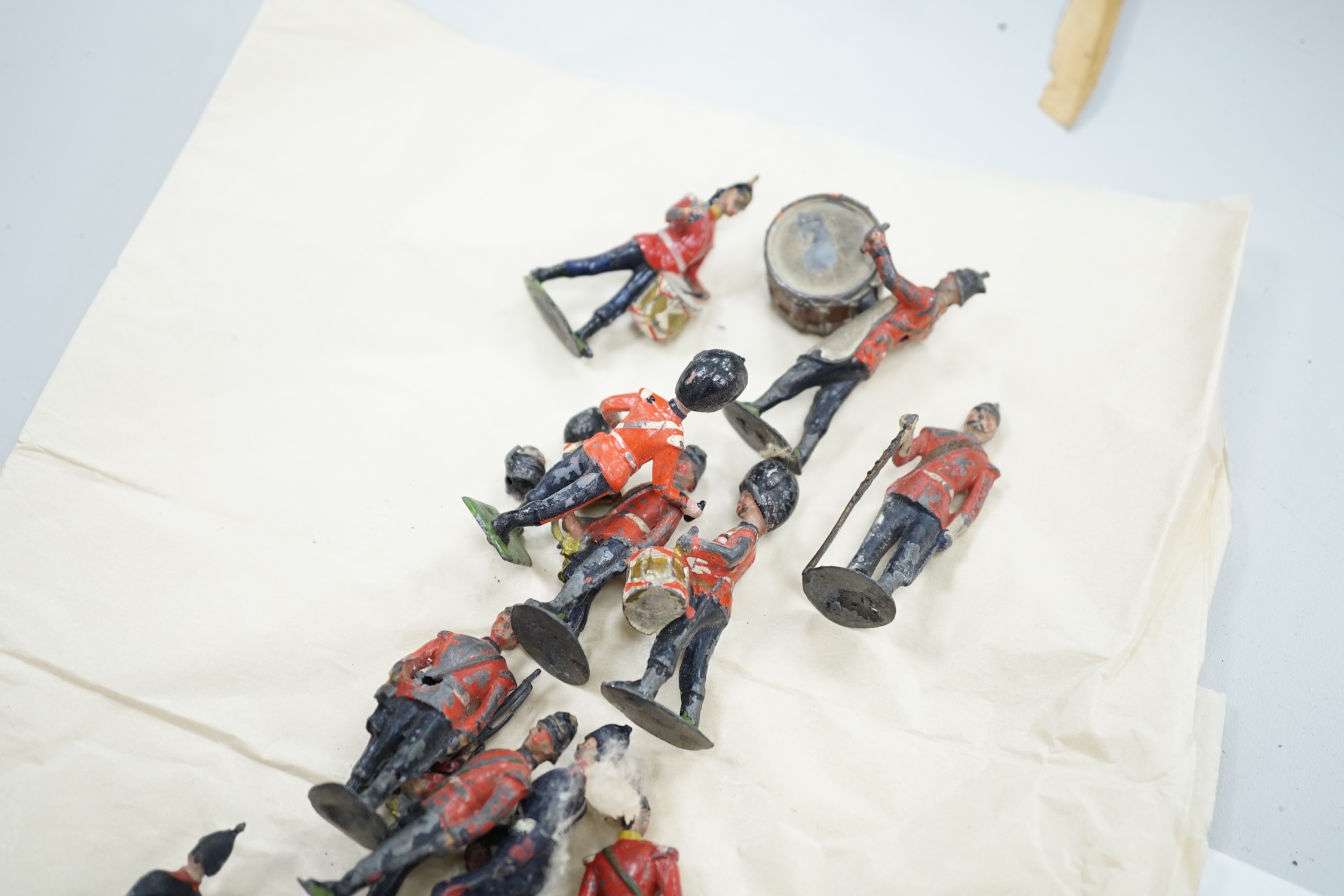 Forty-four early twentieth century Britains, etc. cavalry and infantry soldiers including; Scots Guards, mounted Grenadier Guards, bandsmen, etc. together with a field gun and tinplate lumber